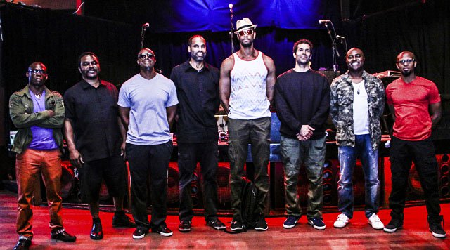 The eight members of Black Poet's Socieity in a line on stage