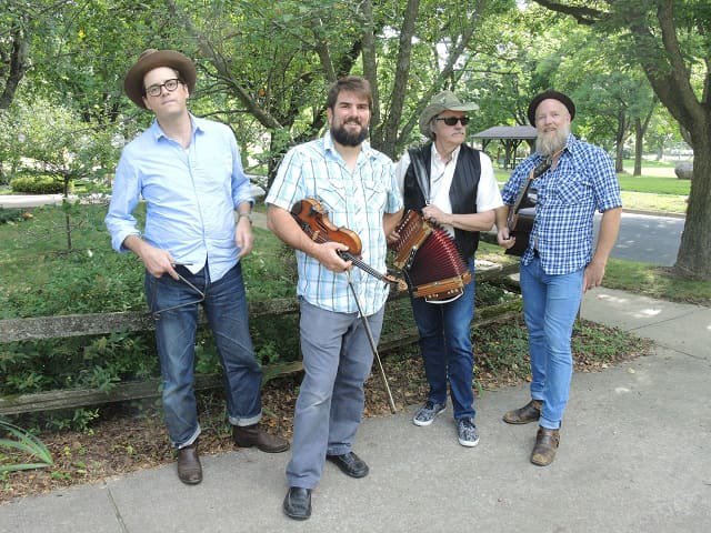 A four piece band on the street corner.