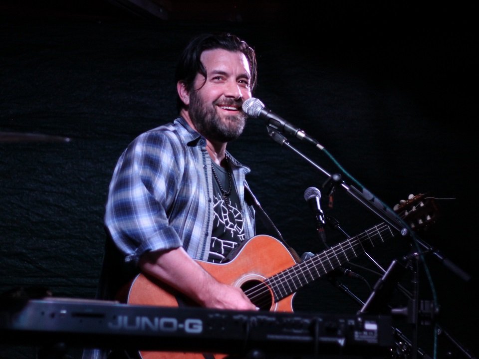 Bob Schneider on stage.