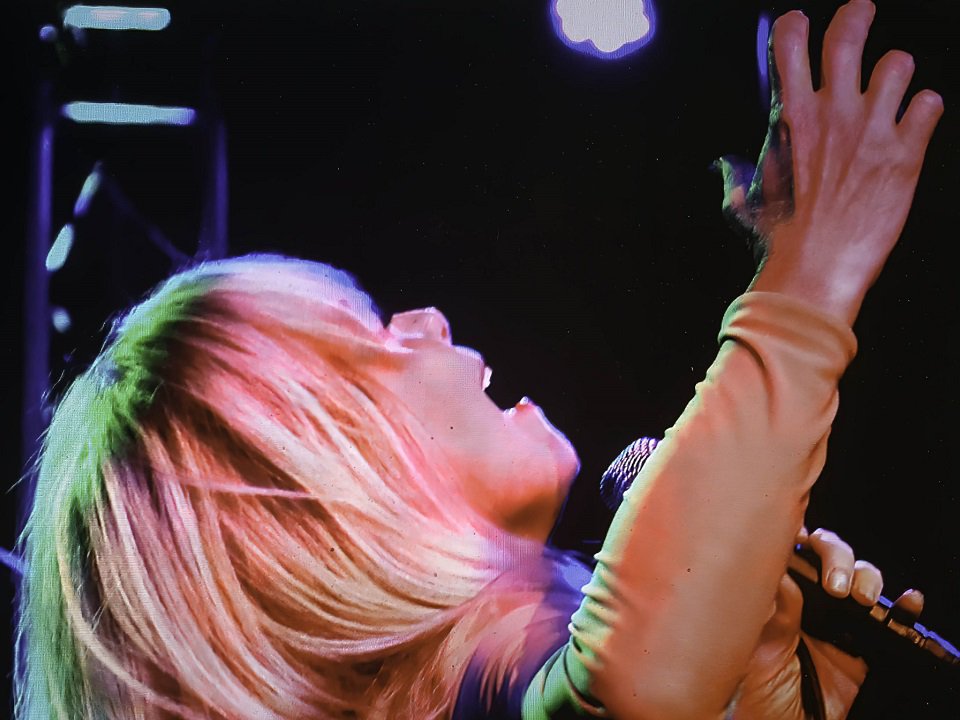 A close-up of Patti Parks singing.