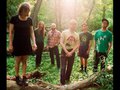 Six people in a woodland glen.