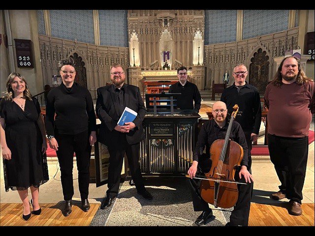 Seven people standing in a church.