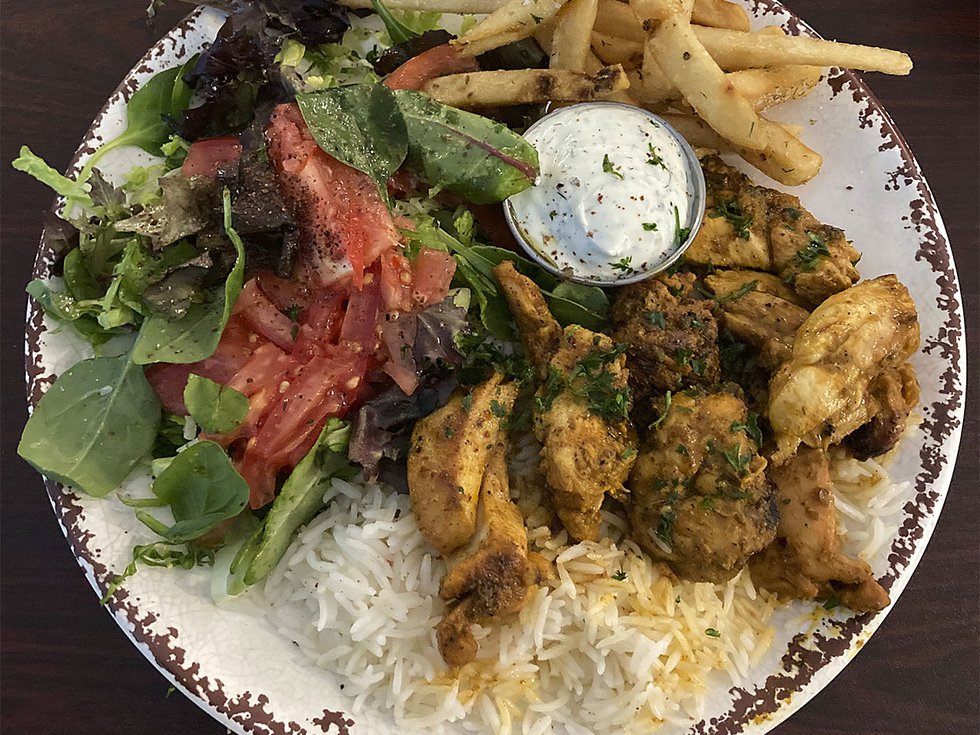 Green salad, chicken on rice and fries.