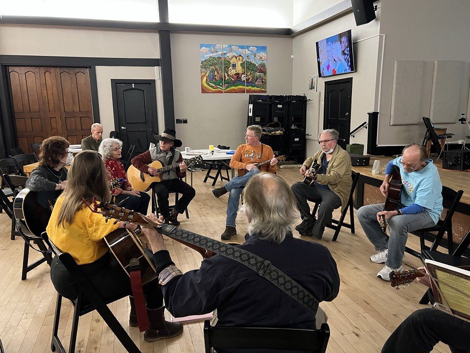 A circle of guitarists.