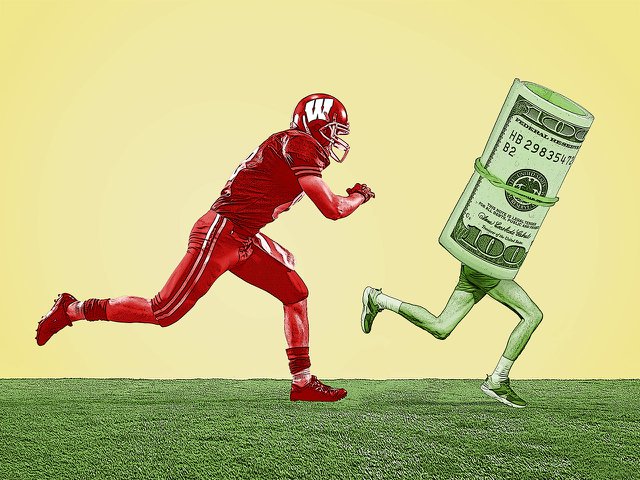 A UW football player chasing down a wad of $100 bills.