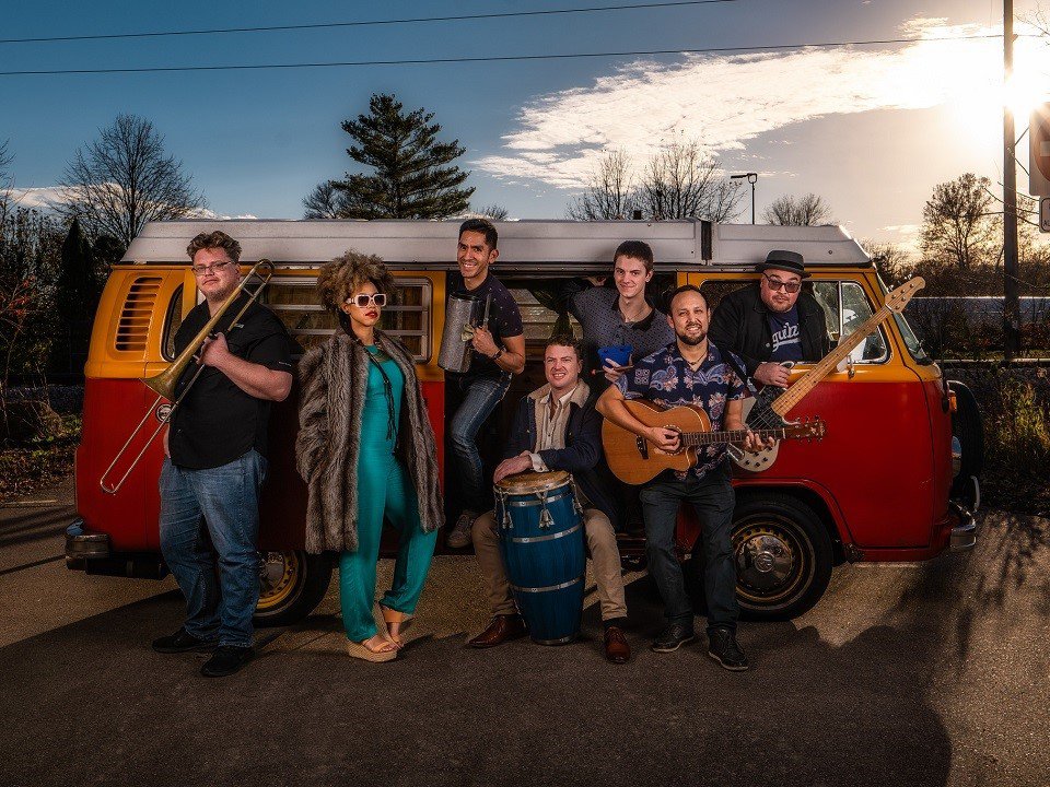 The band La Combi in front of a VW van.