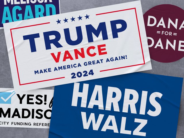 Harris and Trump stickers pasted over stickers for Dana Pellebon, Melissa Agard, and the city budget referendum.