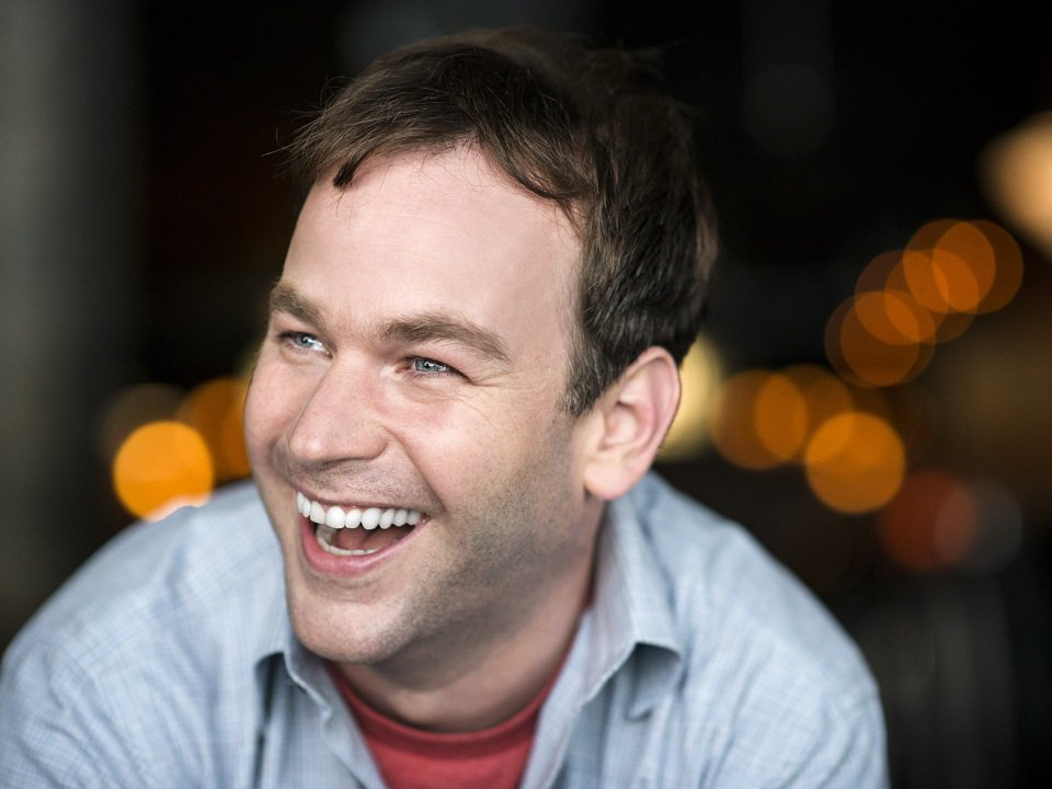 A close-up of a smiling Mike Birbiglia.