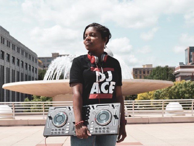 DJ Ace in front of a fountain.