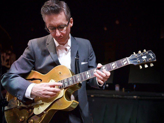 Joel Paterson playing guitar.