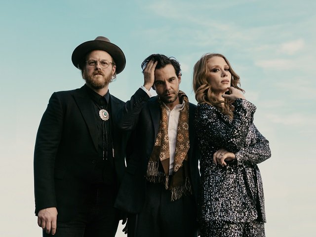 The three members of The Lone Bellow against a backdrop of sky.