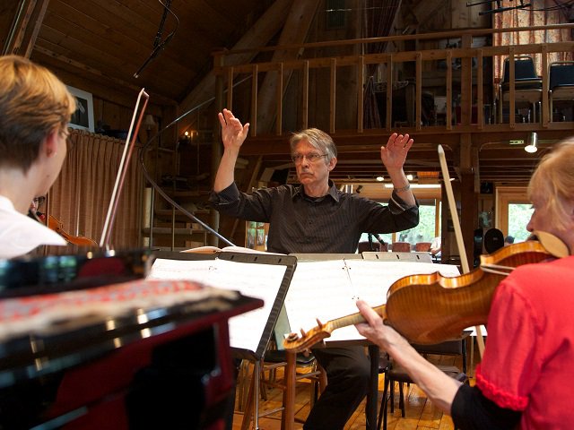 John Harbison conducting rehearsal with ensemble.