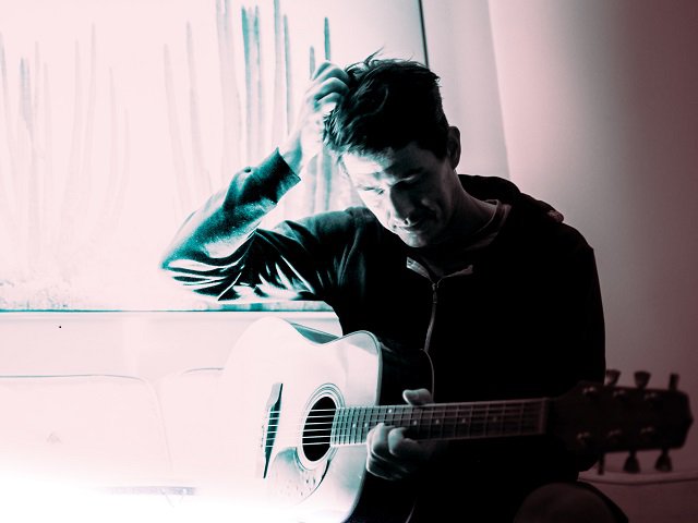 Justin Raudebush with guitar.