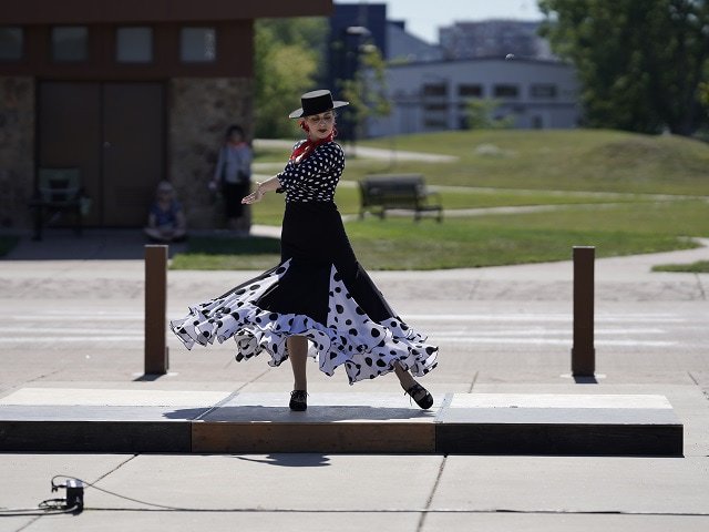 A dancer performs near a bike path.