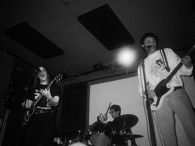 The three members of Substitute on stage.