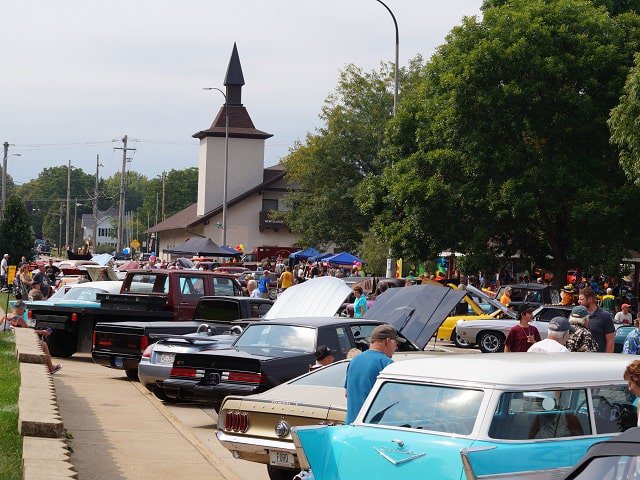 A line of vintage vehicles at New Glarus Family Fest.