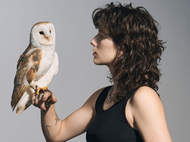 A person with an owl.