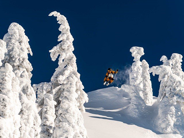 A skiier suspended in midair.