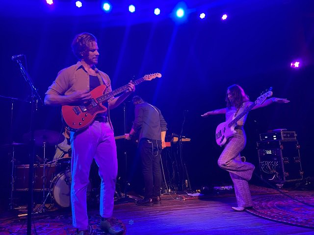 Members of The Ballroom Thieves onstage in blue light.