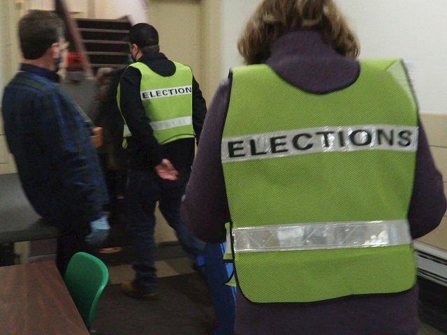 People wearing "ELECTIONS" vests.
