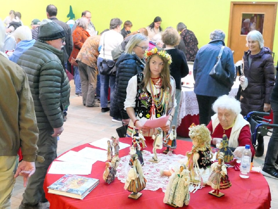 Shoppers and a display of dolls.