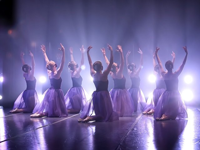 A group of dancers on stage.