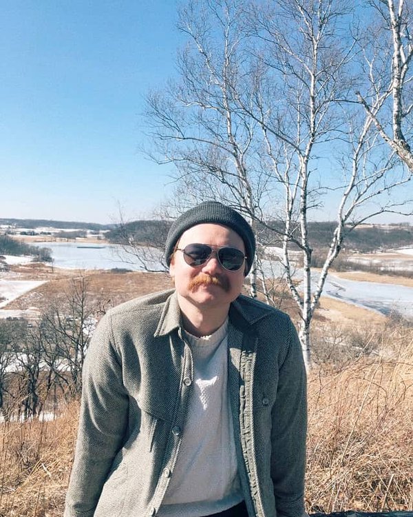 A person in front of a winter Wisconsin landscape.