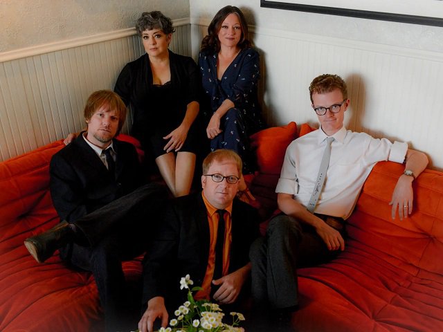 The members of The Flat Five on a couch.