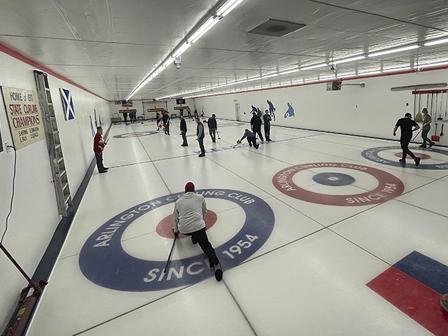 Many curlers on curling ice in Arlington.