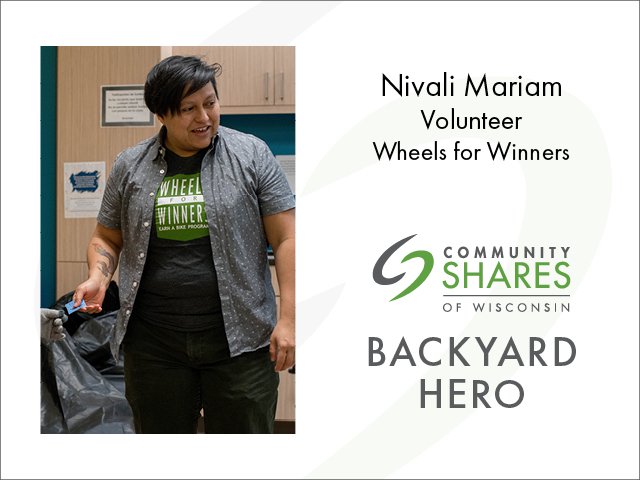 Community Shares of Wisconsin Backyard Hero Nivali Mariam, a Wheels for Winners volunteer, smiling and wearing a shirt that says Wheels for Winners Earn a Bike Program.