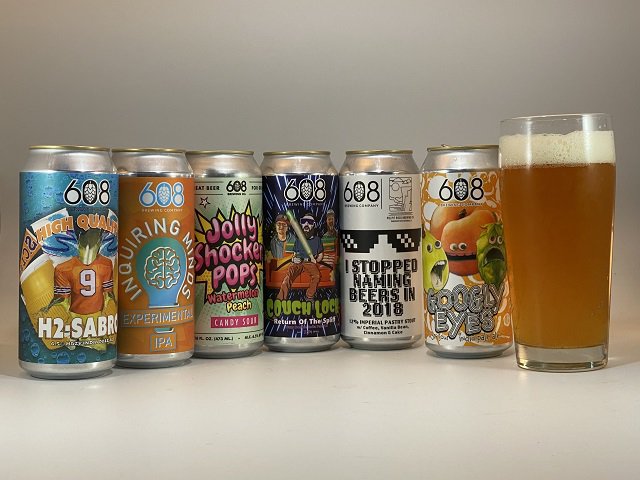 A series of beers in cans from 608 Brewing with a glass of beer on far right.