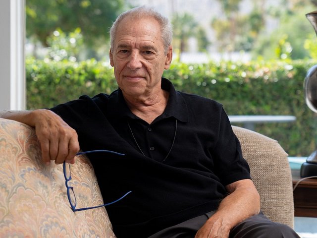 Ben Sidran sitting on a couch.