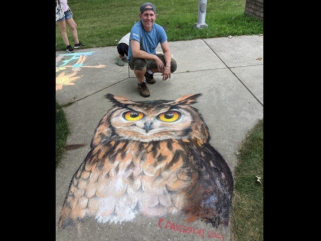 Artist Peter Davidson and a chalk owl drawing.