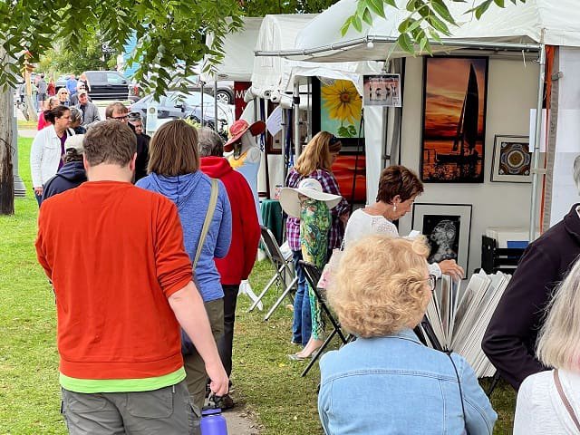 People viewing outdoor artist booths.