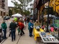 Sidewalk displays and folks on the sidewalk.