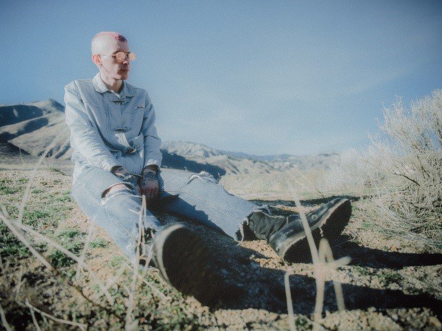 A person sitting in the dirt.