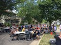 Tables on the street filled with people.