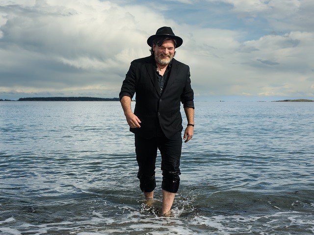 A person walking in a large body of water.