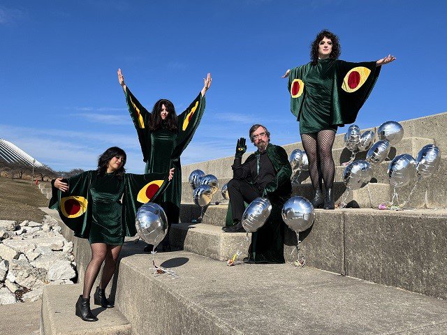 Four people and balloons on some giant steps.