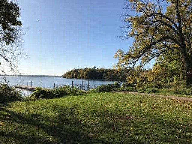 A grassy area and a lake.