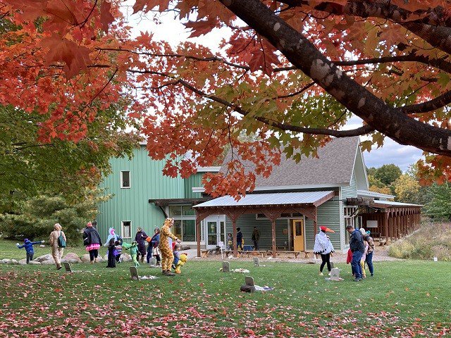 People in costumes in a fall landscape.