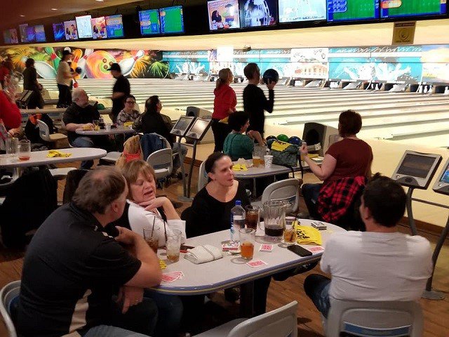 Bowling lanes filled with people.