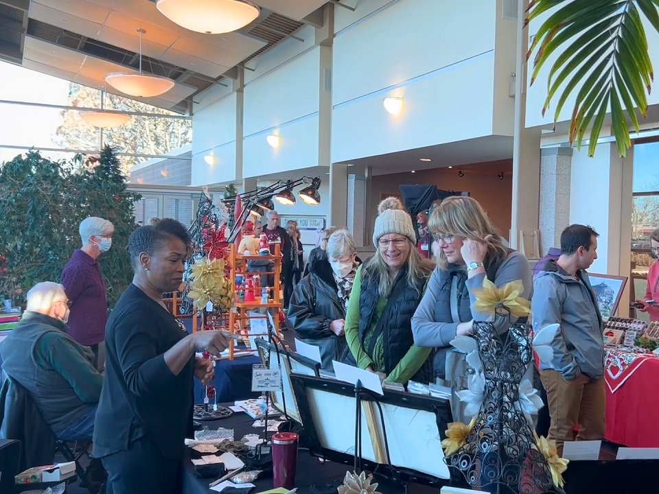 Shoppers examine vendor booths.