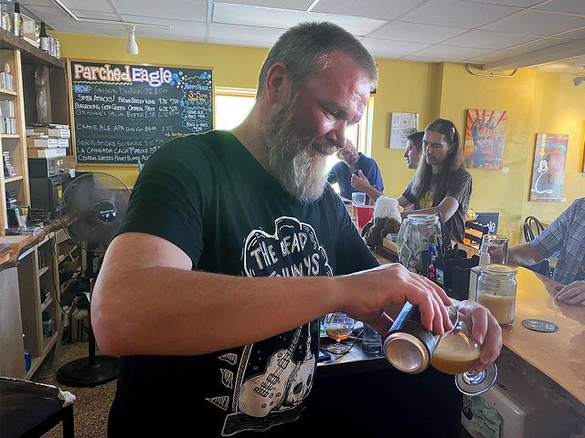 Jim Goronson pouring beer at the bar.