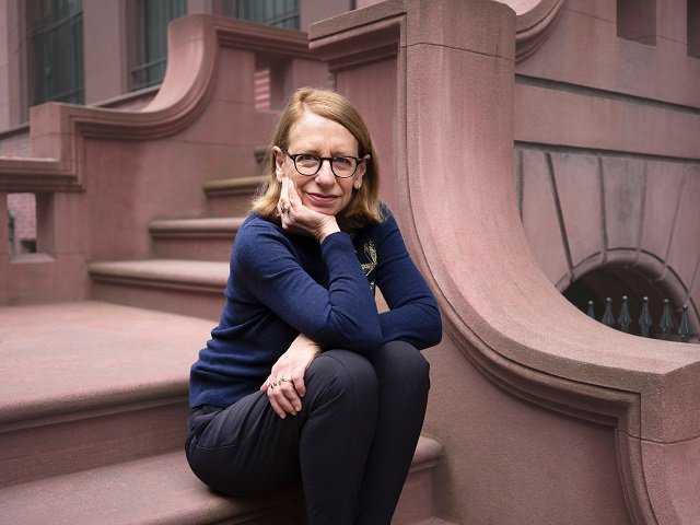Roz Chast sitting on stairs.