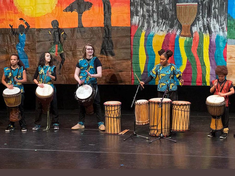 A group of kids drumming.