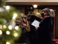 A choir by a Christmas tree.