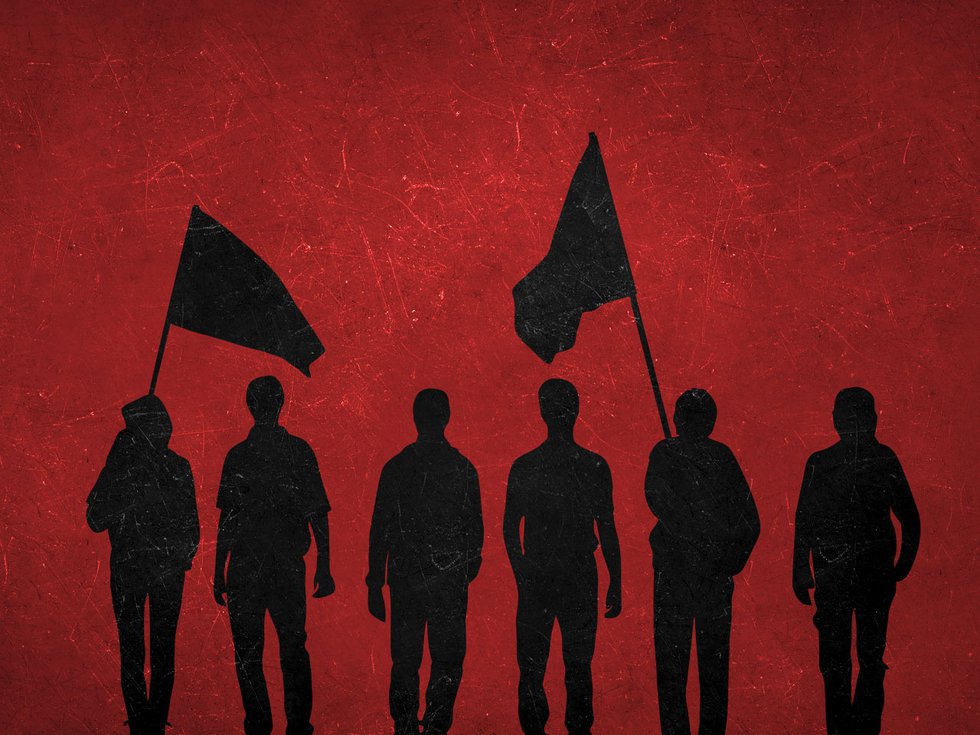 A group of silhouetted demonstrators in front of a red background.