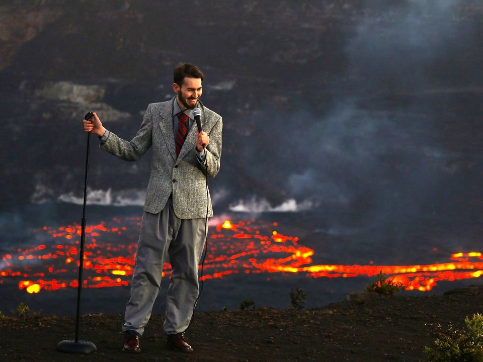 Ben Miller in front of a picture of lava.