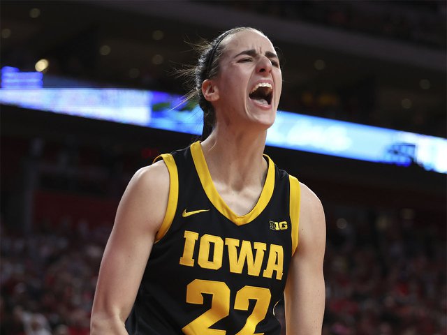 Caitlin Clark on court in Iowa jersey yelling.